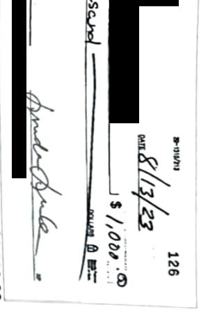 Check with personal information redacted showing signatures for comparison